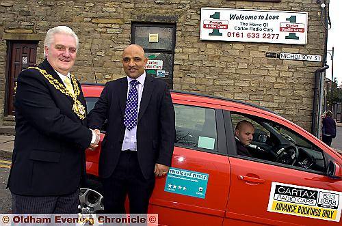 Mayor of Oldham Councillor Jim McArdle with Cartax owner Farooq Yousaf and driver Stephen Fowles. Mayor of Oldham Councillor Jim McArdle with Cartax owner Farooq Yousaf and driver Stephen Fowles.