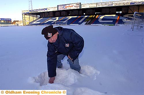 SNOW-GO: Warren Caine, a member of the Athletic groundstaff, checks the depth of the snow at Boundary Park.