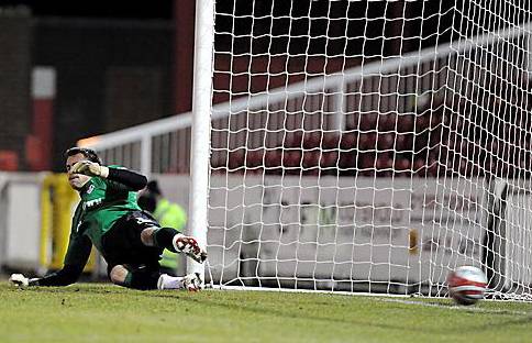 Dean Brill is beaten by the penalty. 

