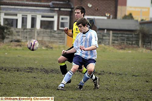 Lee Ashton, of Failsworth Dynamos, plays a lofted pass under the watchful eye of High Crompton CC’s Anthony Duffy.