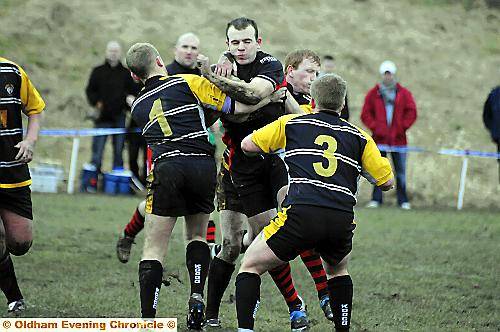 Higginshaw’s Sean Stubbs takes on the Widnes defence in the local side’s easy win. 