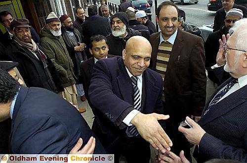ON your side now . . . Basit Shah shakes hands as he switches from Labour to Tory at the Conservative campaign HQ 