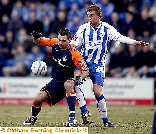 I’M BEHIND YOU: Athletic striker Pawel Abbott shields the ball from Matt Heath.