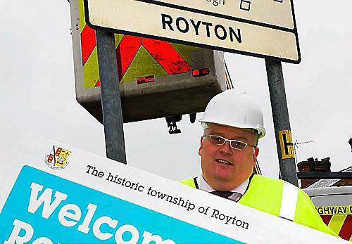 Flashback . . . Oldham’s Lib-Dem council leader Howard Sykes helps fit the first new sign in Royton Flashback . . . Oldham’s Lib-Dem council leader Howard Sykes helps fit the first new sign in Royton