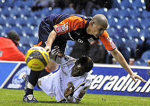 FALL GUYS: Leeds United’s Max Gradel goes to ground under a challenge from Athletic defender Kelvin Lomax. 