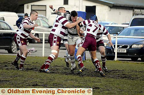 HELD: Saddleworth’s Jason Best takes some stopping in his side’s 34-6 win over Millom in National Conference League division one. 