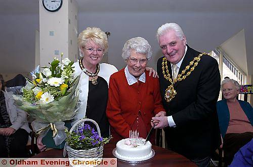 The Mayor and Mayoress, Councillors Jim McArdle and Kay Knox, help Miss Brierley slice her birthday cake The Mayor and Mayoress, Councillors Jim McArdle and Kay Knox, help Miss Brierley slice her birthday cake