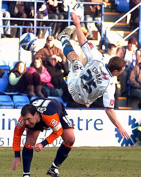 UP AND OVER: Craig Curran, of Tranmere Rovers, takes a tumble under a challenge from Athletic defender Sean Gregan. 
