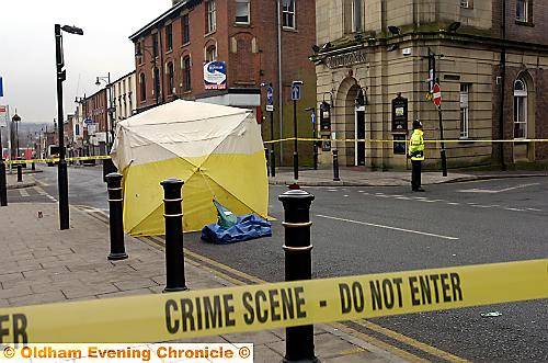 CRIME scene . . . police guard the area 