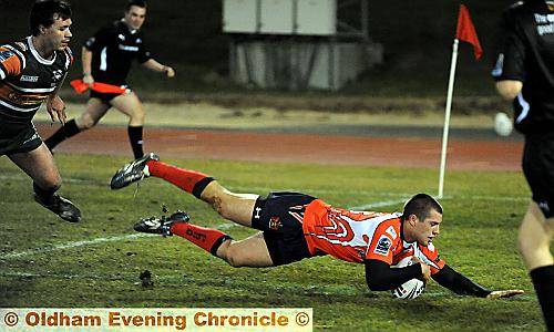 OVER YOU GO . . . Joe Chandler caps a fine performance with his try. 

