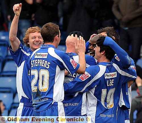 MILES OF SMILES: Reuben Hazell is the centre of attention after heading Athletic into the lead.