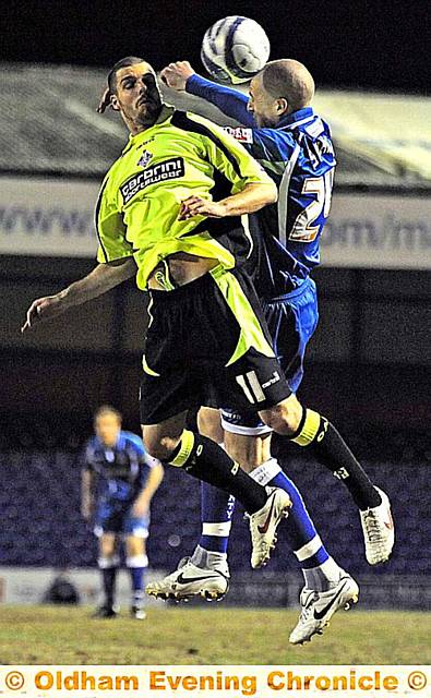 AERIAL COMBAT: Athletic’s on-loan forward Lewis Guy jumps for a header in last night’s relegation scrap at Stockport County.