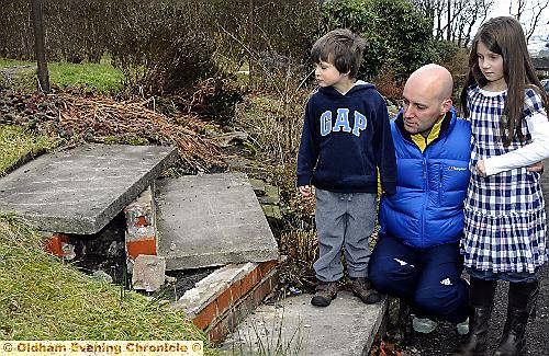 Stewart George and his children, Joe and Lucy, survey the damage after the refuse wagon wrecked their garden steps Stewart George and his children, Joe and Lucy, survey the damage after the refuse wagon wrecked their garden steps