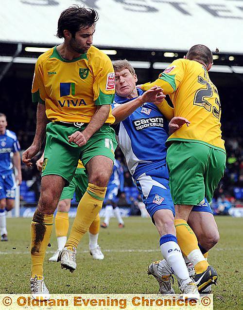 OUCH! Athletic midfielder Joe Colbeck is caught in a Norwich City sandwich.