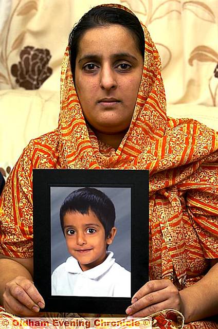 COME home . . . tearful Akila Naqqash clings to a picture of kidnapped son, Sahil 