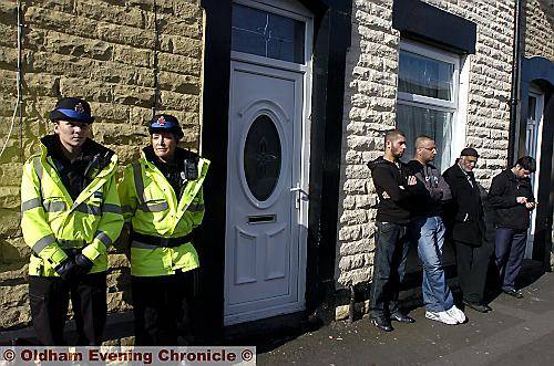 ON guard . . . police officers kept a vigil outside the family home in Queen Street, Shaw, as concerned relatives and friends gather to wait for news 