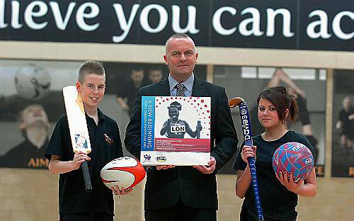 headteacher John Meagher celebrates the award with pupils Patrick Jagger and Jude Laryea. 