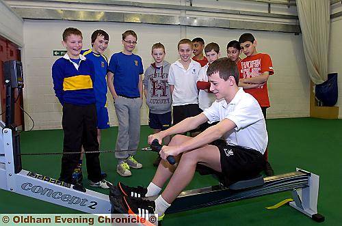 PULLING TOGETHER . . . there is plenty of encouragement for Adam Crossman (12) from Crompton House as he displays his rowing technique. 