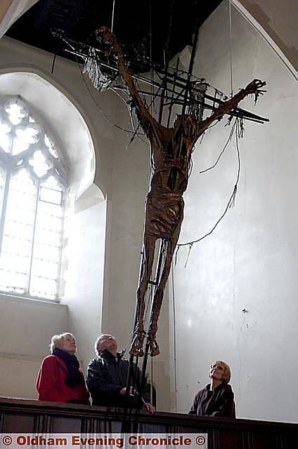 The striking sculpture hanging in St Anne’s Church, Royton, is viewed by, from left to right: Jennifer and Stewart Barker, and church warden Sylvia Coppock. 