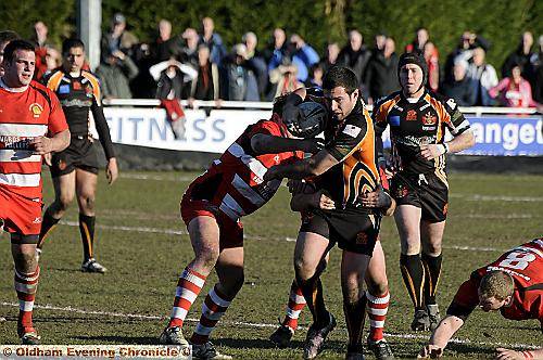 POWER PLAY . . . Oldham’s stand-out performer Matty Ashe drives his team forward. 