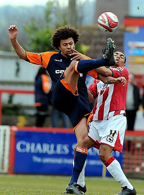 HIGH KICK: Athletic’s on-loan forward Jason Price manages to toe the ball away from Exeter City defender Scott Golbourne. 