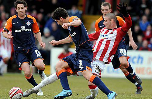 ATHLETIC full-back Joe Jacobson challenges Marcus Haber. 