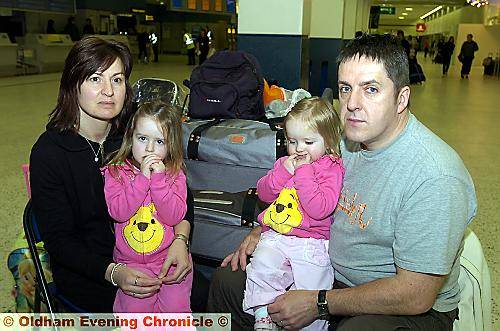 GOING nowhere . . . James O’Neill with wife Nikki and daughters Tia (left) and Ava stranded at Manchester Airport