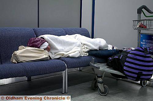 STRANDED . . . this passsenger beds in at the airport 