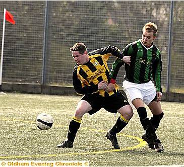GET BACK: Dale Whipp, of Fitton Hill Rangers, holds off Highfield United’s Keith Kurpass. GET BACK: Dale Whipp, of Fitton Hill Rangers, holds off Highfield United’s Keith Kurpass.