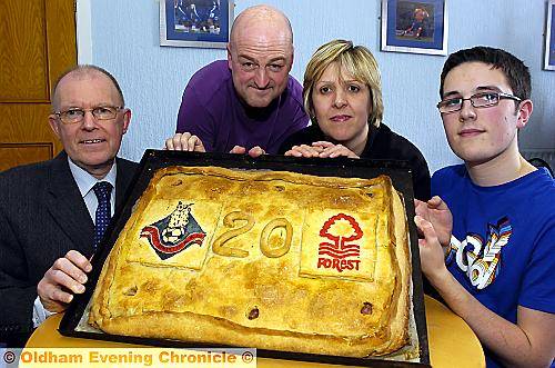 Athletic chief executive Alan Hardy (left), is presented with the commemorative pie by Mark and Gillian Bradley and their son Sam Bradley. Athletic chief executive Alan Hardy (left), is presented with the commemorative pie by Mark and Gillian Bradley and their son Sam Bradley.