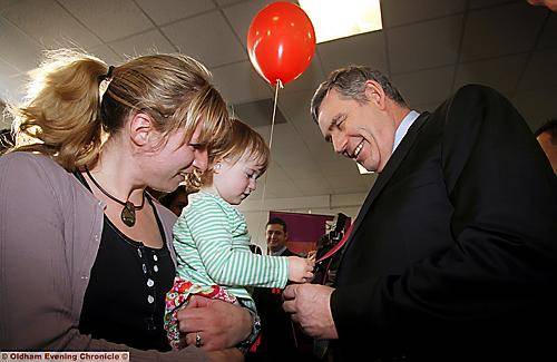 Elva Roberts (21 months), with her mother Kirsty Roberts, plays with the Prime Minister’s tie at the Honeywell Centre 