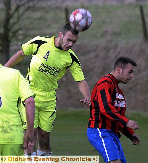 AERIAL ACTION: Royton FC’s Scott Conroy leaps to head clear from Khartoum Northern’s Roy Radcliffe. 