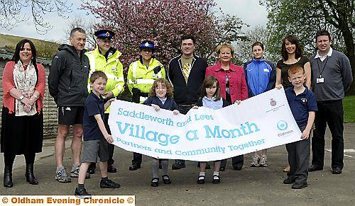 WE’RE in this together . . . children and officials show off the banner 