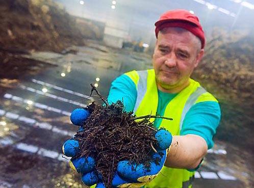 MIXING it up . . . employee Mick Jacques at the recycling facility at Waithlands, Rochdale 
