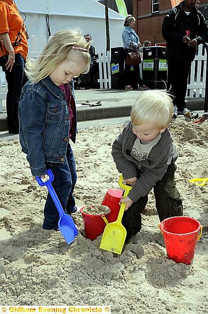 GET digging . . . Jessica Lawrence (4) and Matthew Lawrence play on the beach.