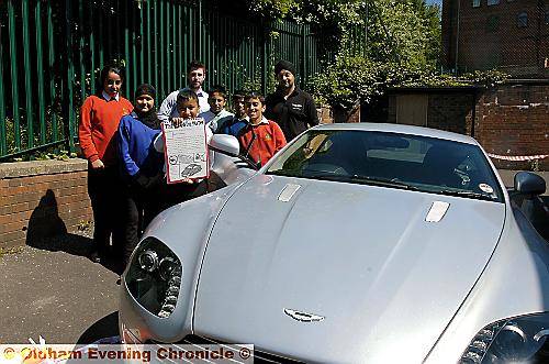 Henna Tobassum with his car report, and fellow writers (from the left) Hannan Butt, Fayzhan Khan, Mariam Abadak, Abbas Hussain and Nakash Hussain, join Aston Martin’s Jonathan Hoad and Bal Choda by the gleaming Vantage model. (TOP LEFT) Abbas Hussain waxes lyrical about the Aston Martin DBS in his report 