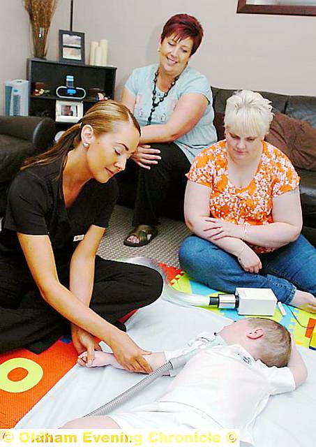AARON gets a gentle aromatherapy massage from Lisa Lees, watched by mum Paula (right) and case manager Chris Krastins AARON gets a gentle aromatherapy massage from Lisa Lees, watched by mum Paula (right) and case manager Chris Krastins