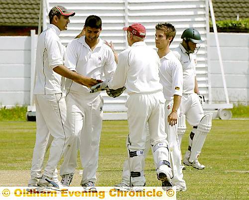 PUT IT THERE: Crompton players celebrate the wicket of Royton’s Simon Brierley. PUT IT THERE: Crompton players celebrate the wicket of Royton’s Simon Brierley.