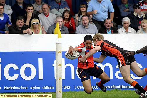 Reach out: Marcus St Hilaire touches down in the corner for Oldham. 
