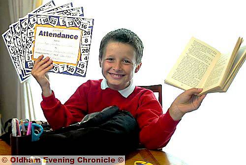 EXCELLENT . . . Ryan Shenton shows off his collection of attendance records