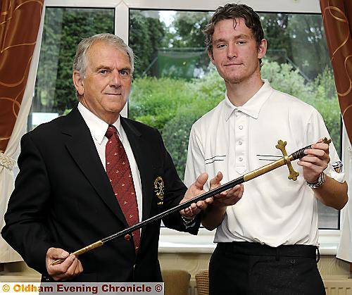 ALL YOURS . . .Crompton and Royton captain Keith Banham presents Chris Rabbich with the Royton Sword. ALL YOURS . . .Crompton and Royton captain Keith Banham presents Chris Rabbich with the Royton Sword.