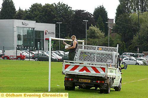 Careful not to dribble! A workman repaints the tatty goalposts
Careful not to dribble! A workman repaints the tatty goalposts