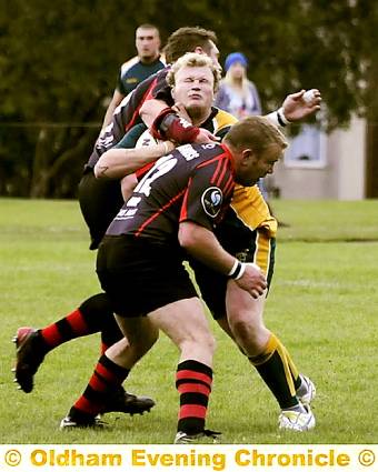 NOWHERE TO RUN . . . Oldham St Anne’s forward Phil Jagger is stopped in his tracks by Callum Hunter, of Stanley Rangers. 