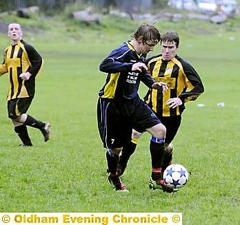CHADDY’S Dominic Smalley (left) controls the ball as he tries to escape the challenge of Fitton Hill’s Dale Whipp in the Premier Division clash. 
