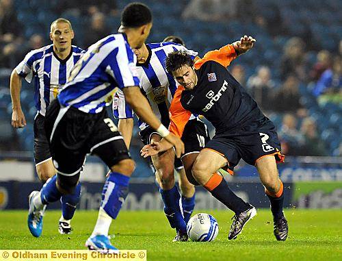 Ducking and diving: Ritchie Jones works his way through a cluster of Sheffield defenders. 
