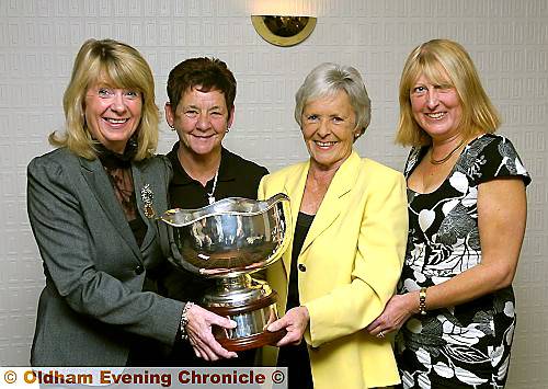 SUE BOOTHBY (left) receives the Joan Hirst Cup from Marie Middleton (chairman of the OLGA), watched by Jane Clark (second from left) and Julie Pickering. 