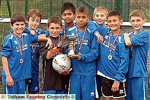 WE DID IT: Mills Hill captain Ellis Simms (centre) and his team-mates show off the trophy and medals they received for winning the Radclyffe School cluster football competition. WE DID IT: Mills Hill captain Ellis Simms (centre) and his team-mates show off the trophy and medals they received for winning the Radclyffe School cluster football competition.