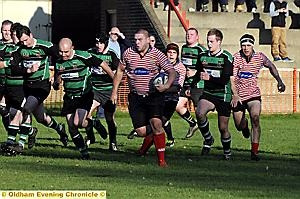 THEY’RE BEHIND YOU: Oldham’s John Souter is pursued by a posse of North Manchester opponents.
THEY’RE BEHIND YOU: Oldham’s John Souter is pursued by a posse of North Manchester opponents.