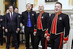 SINGING soldiers: (from right) Sgt Richie Maddocks, Sgt Major Gary Chiltern and L/Cpl Ryan Idzi burst into song in front of the Prime Minister David Cameron. 
