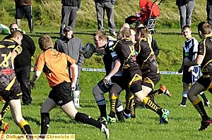 SURROUNDED: Carl Gemmell, of Fitton Hill Bulldogs, has nowhere to go against Ashton Bears ‘A’. 